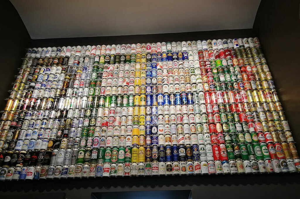 wall of beer cans inside the Bruges Beer Experience